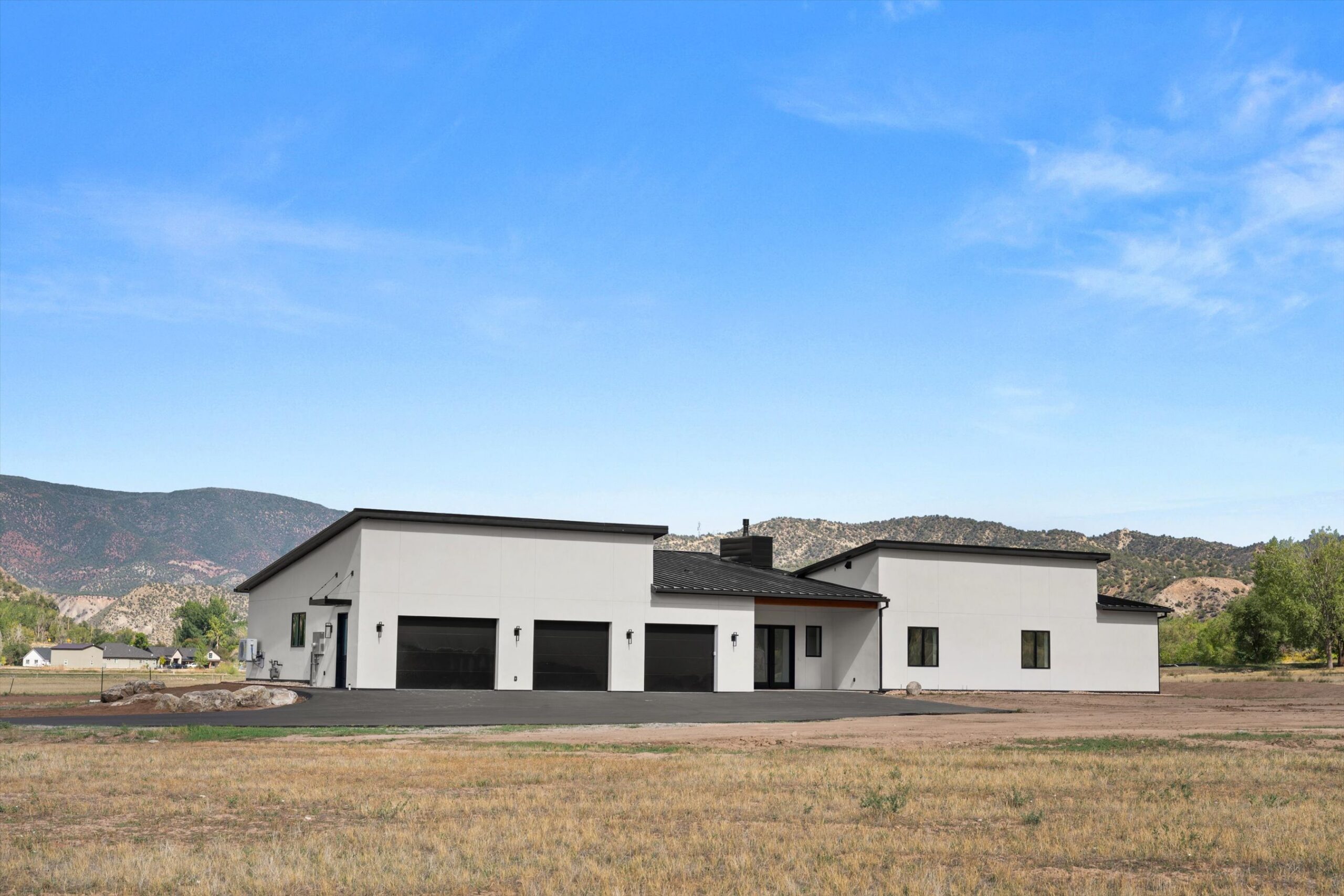 Front elevation with landscaping and distant mountains