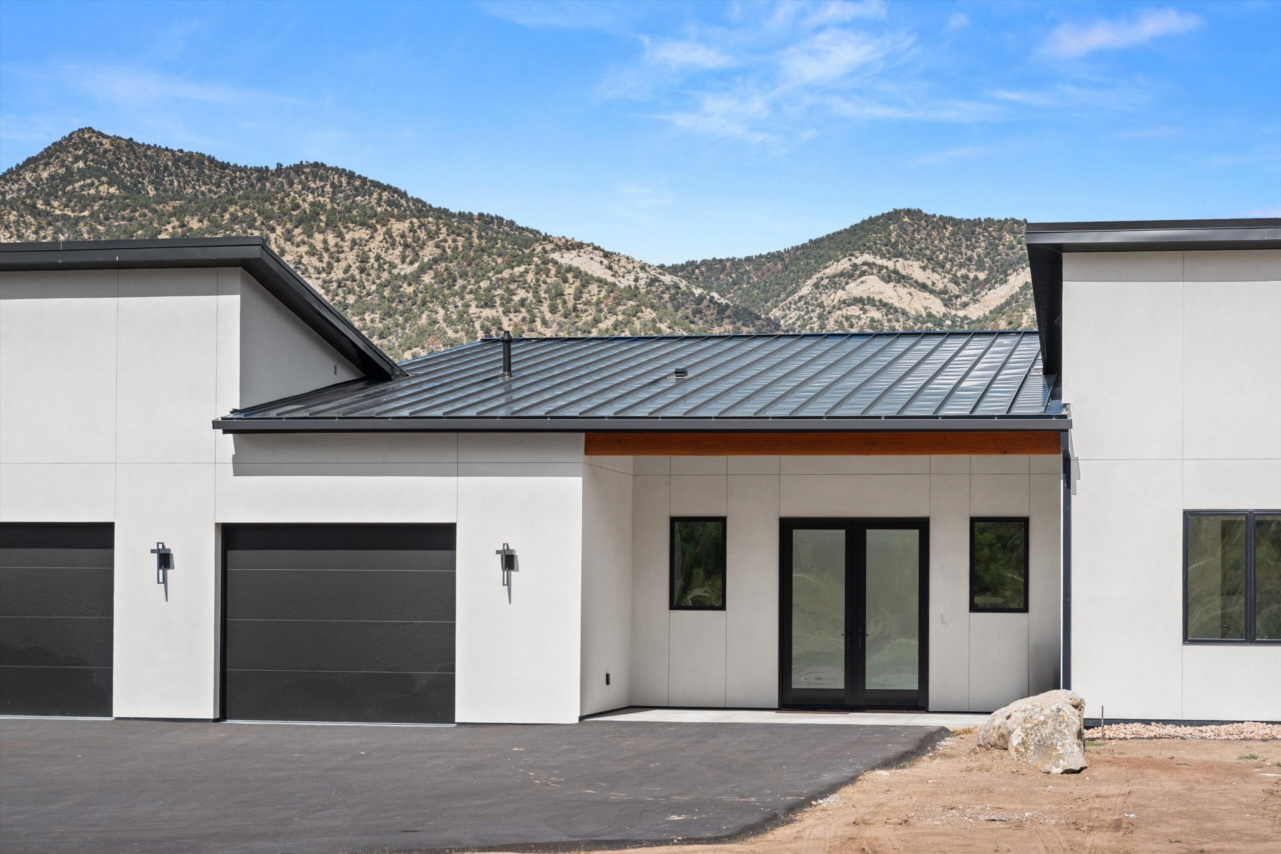Three-car garage doors and front entry detail