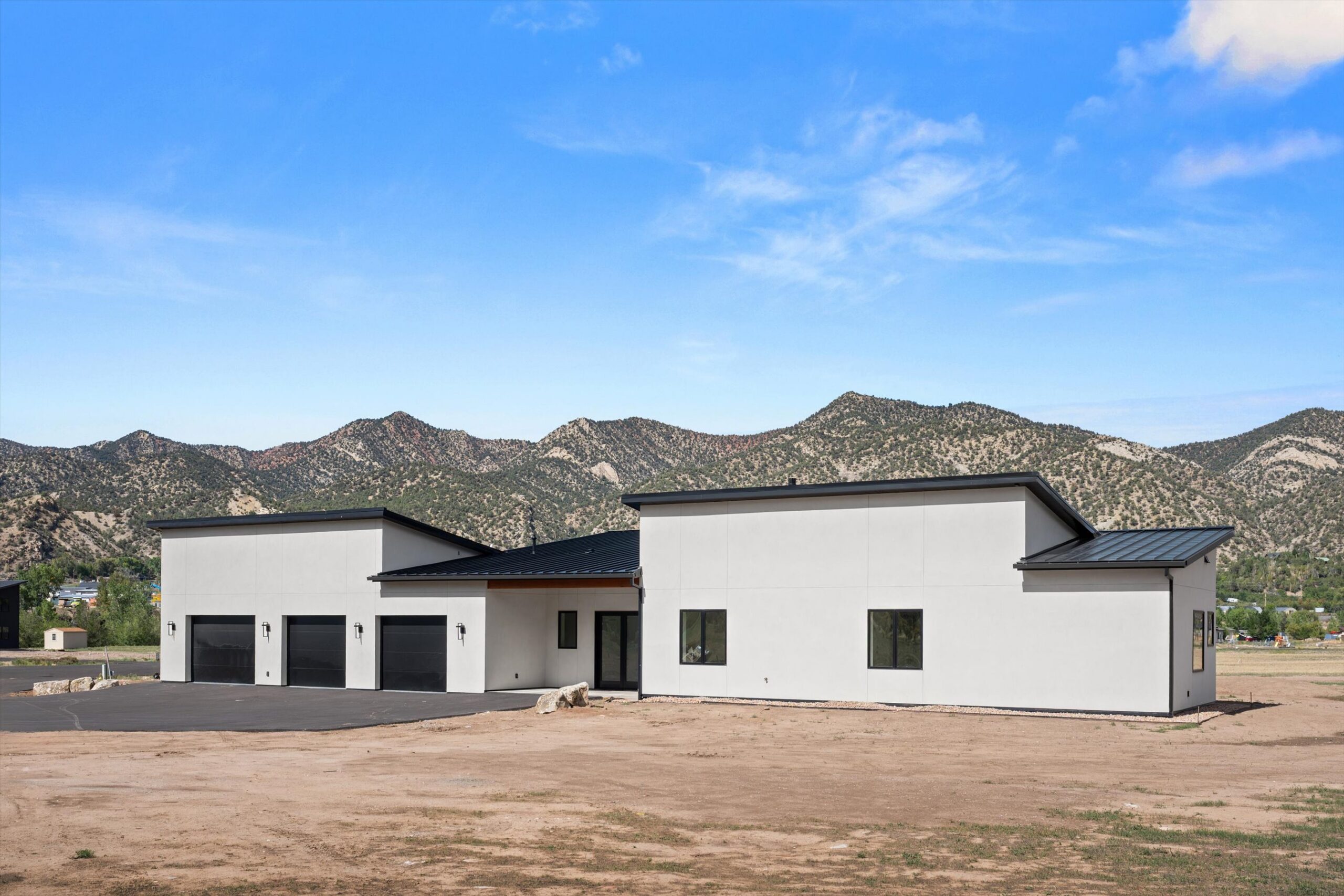 Angled front exterior view with mountain backdrop