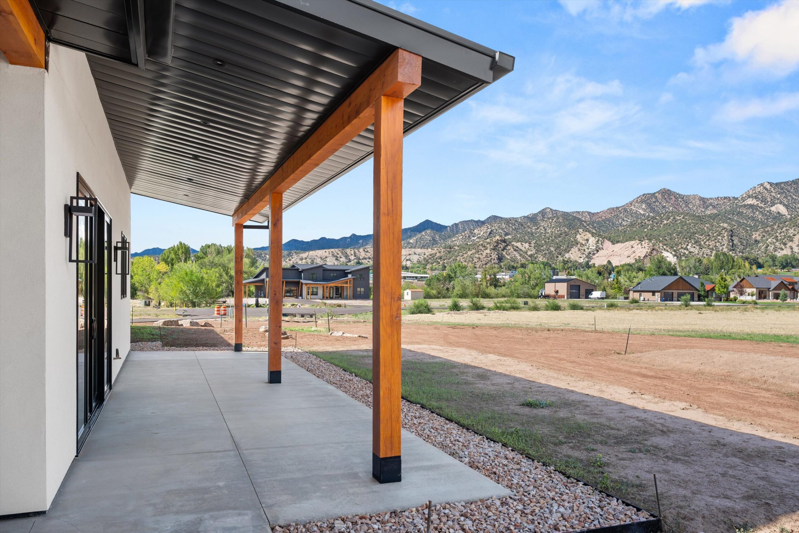 Patio column framing mountain and field view
