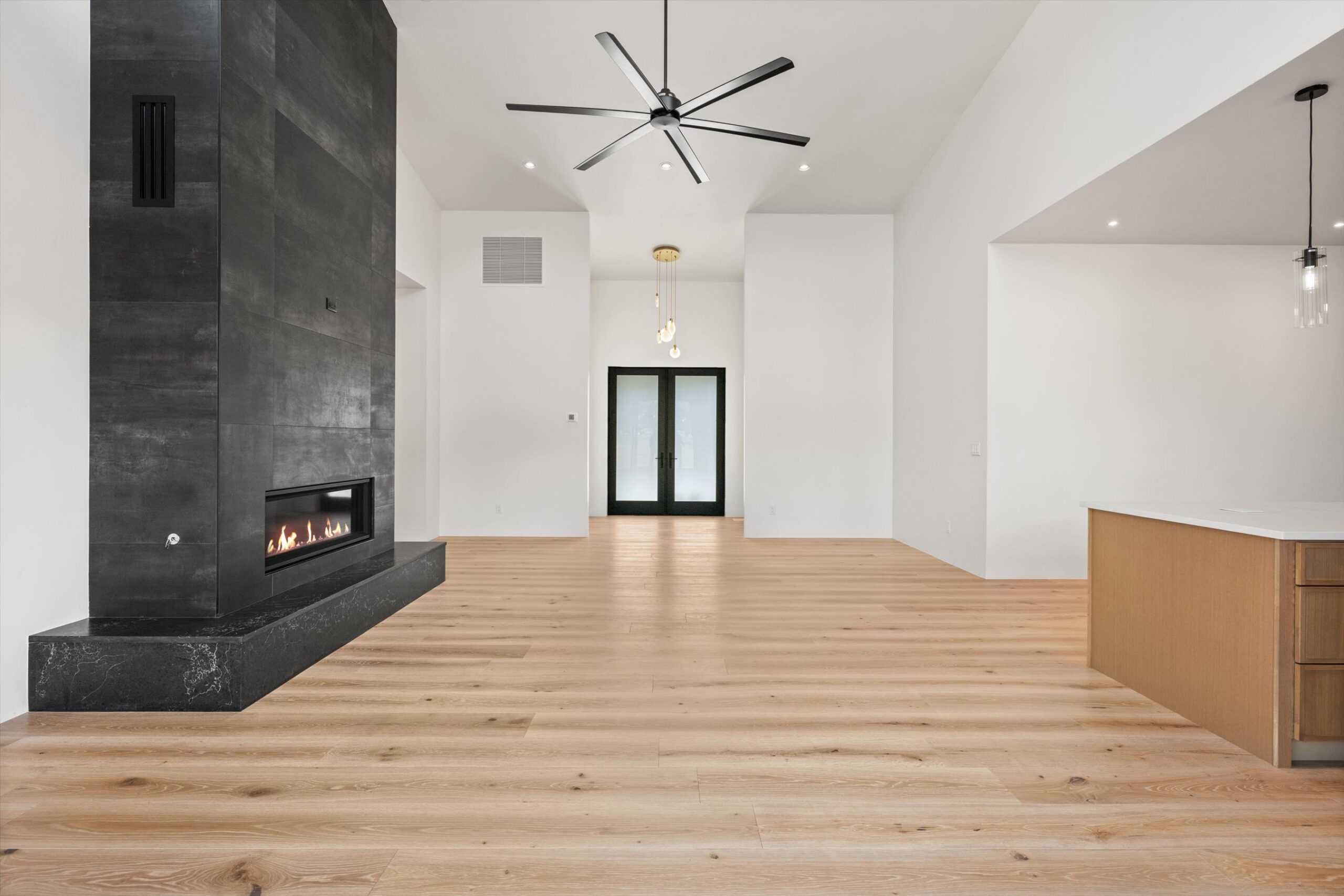 Fireplace detail with kitchen island foreground