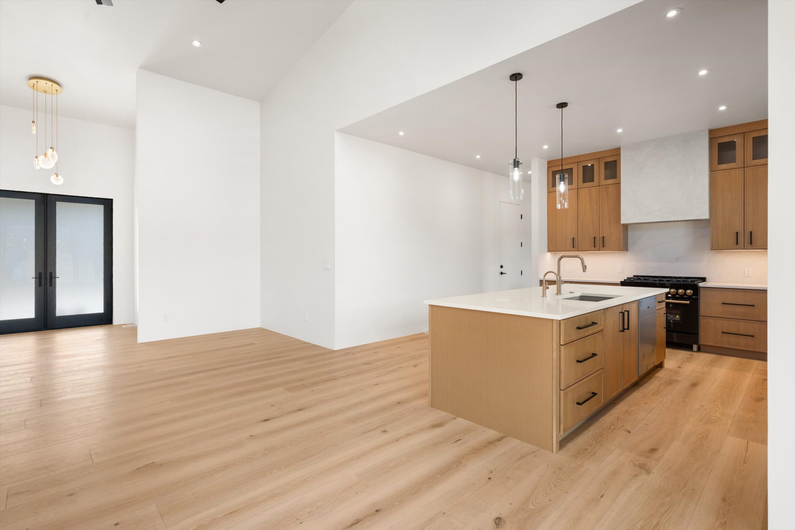 Kitchen island with waterfall countertop and pendants