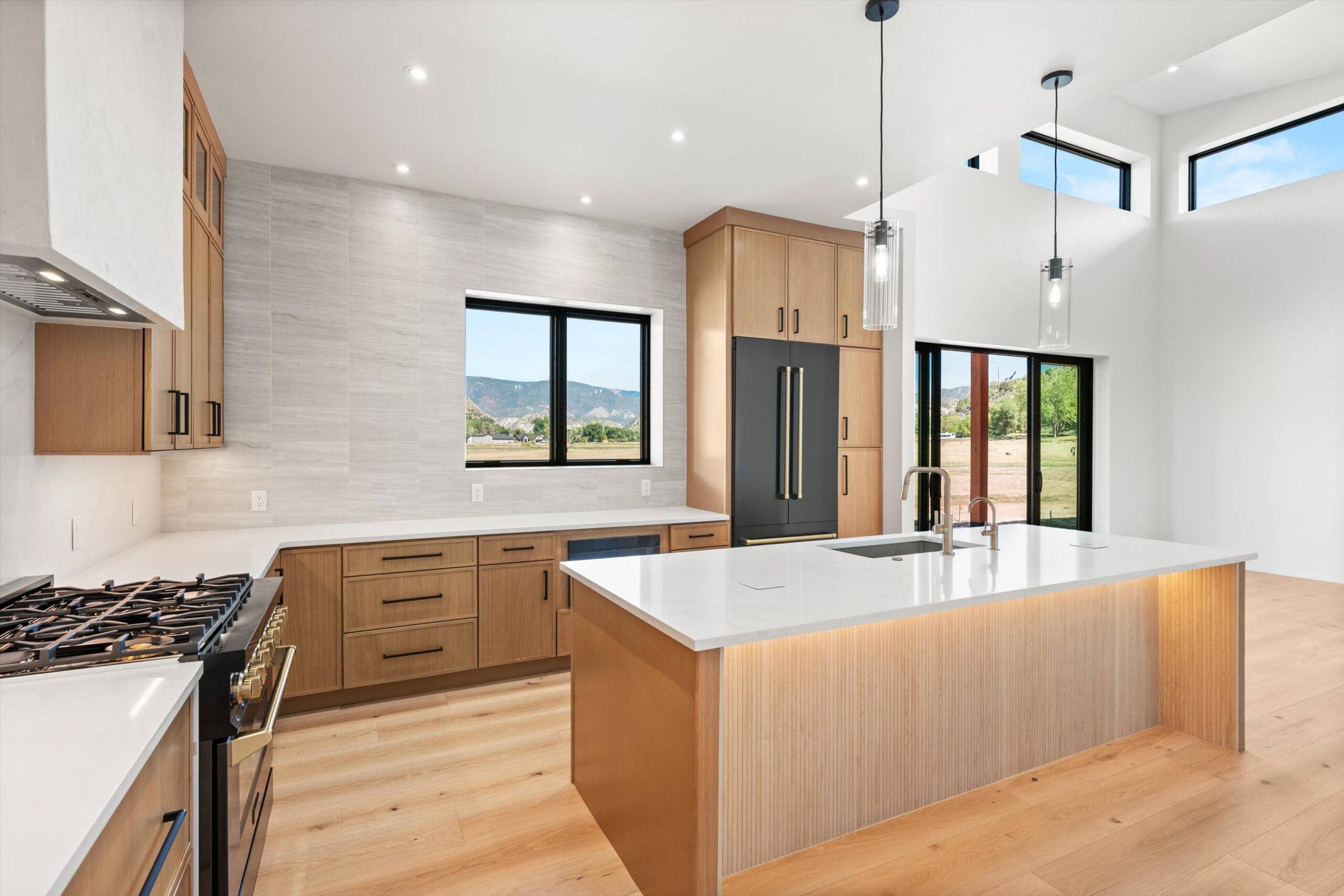 Kitchen island with gold fixtures and mountain views