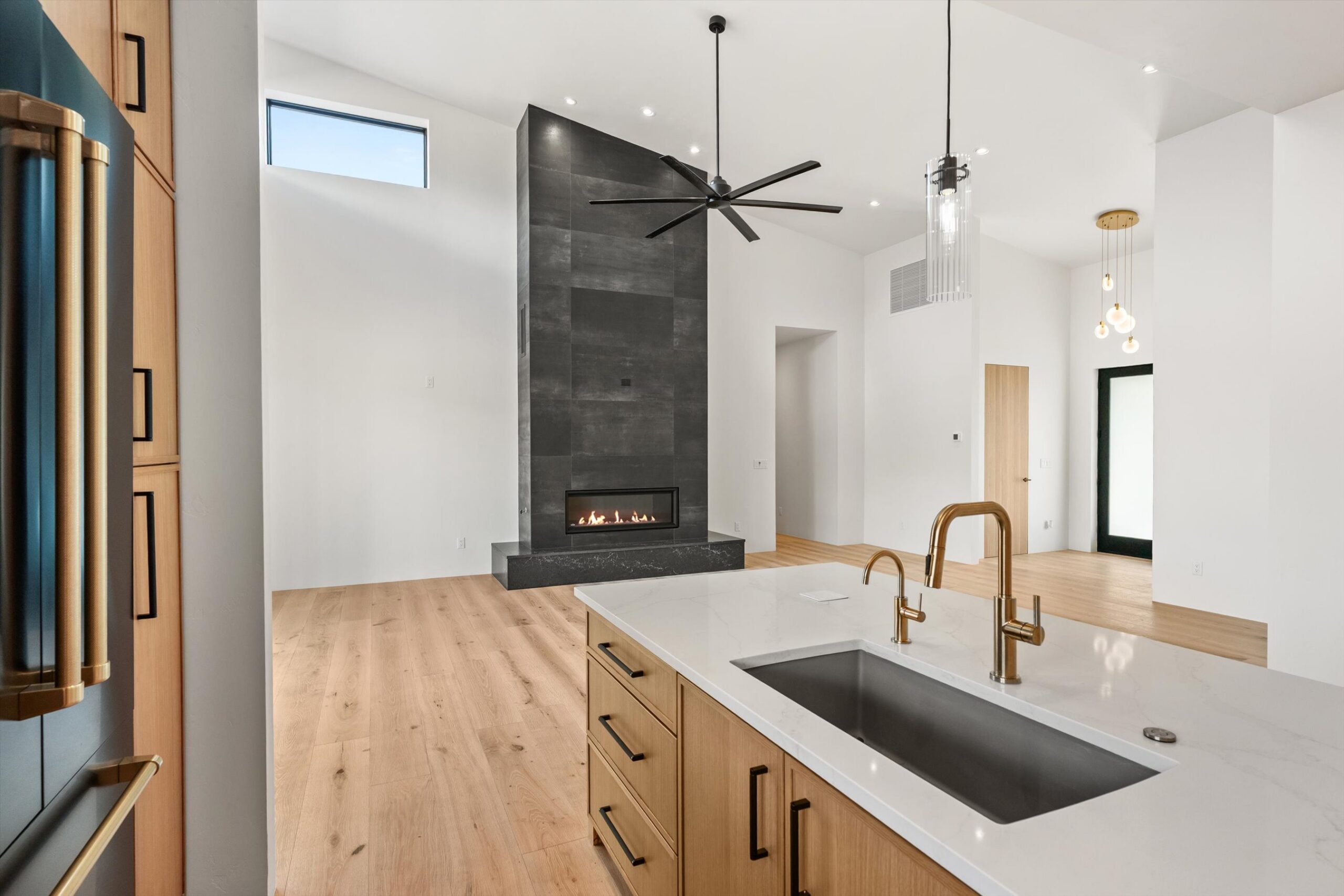 Kitchen sink area with fireplace beyond