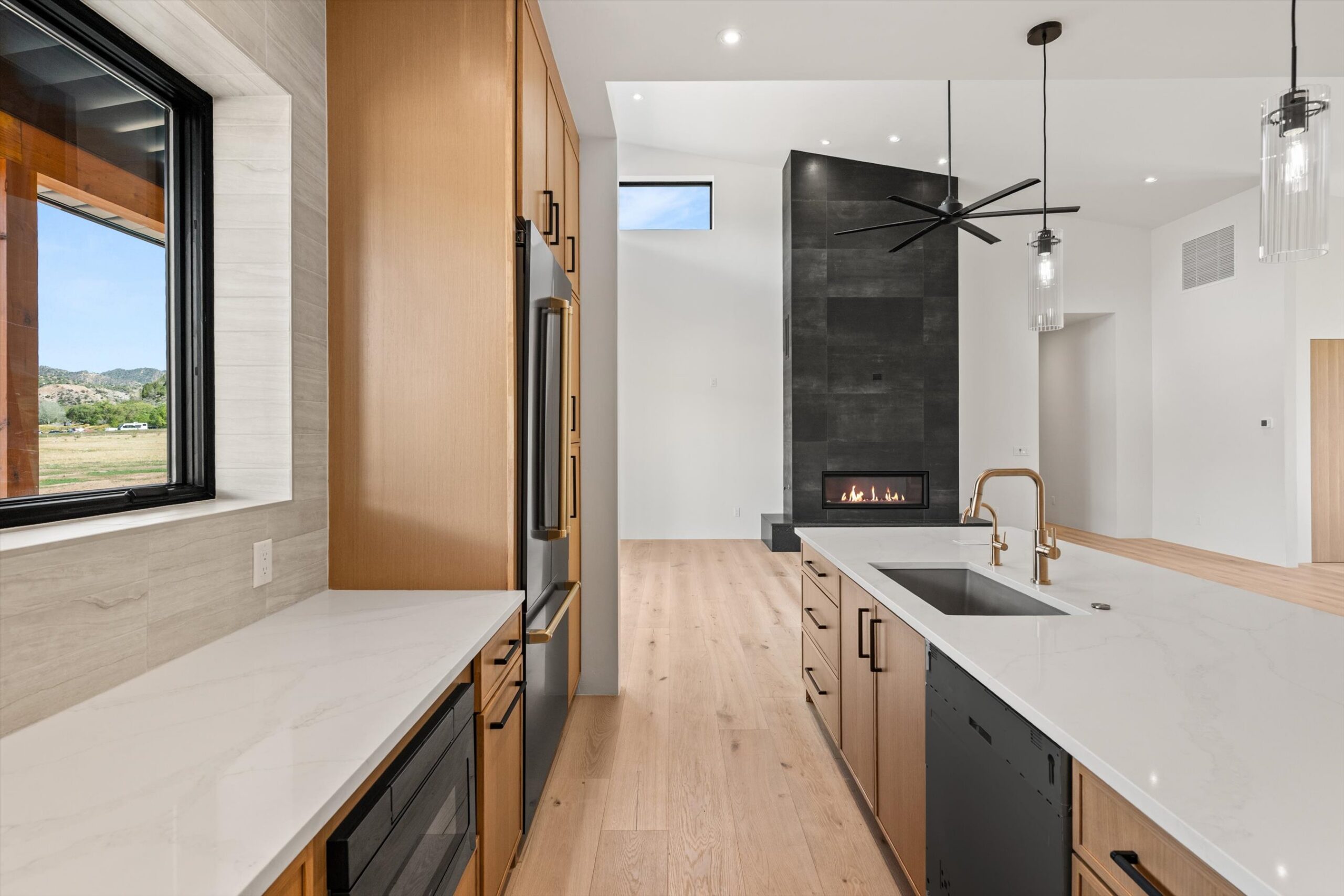 Kitchen corridor with refrigerator and fireplace view