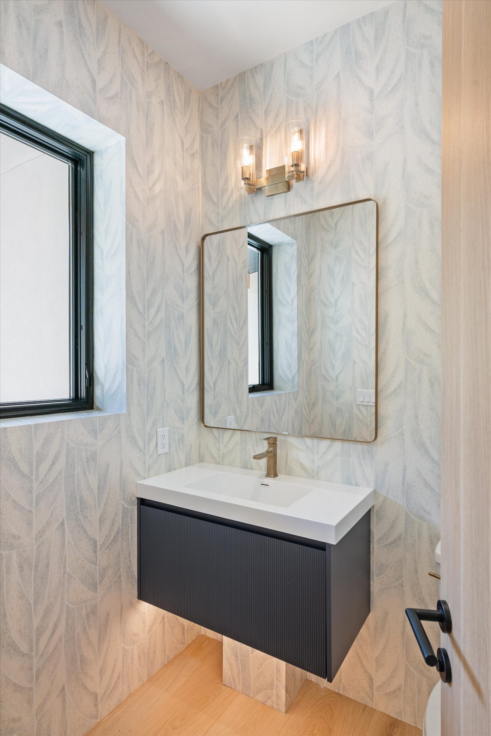 Powder room with wallpaper and floating vanity