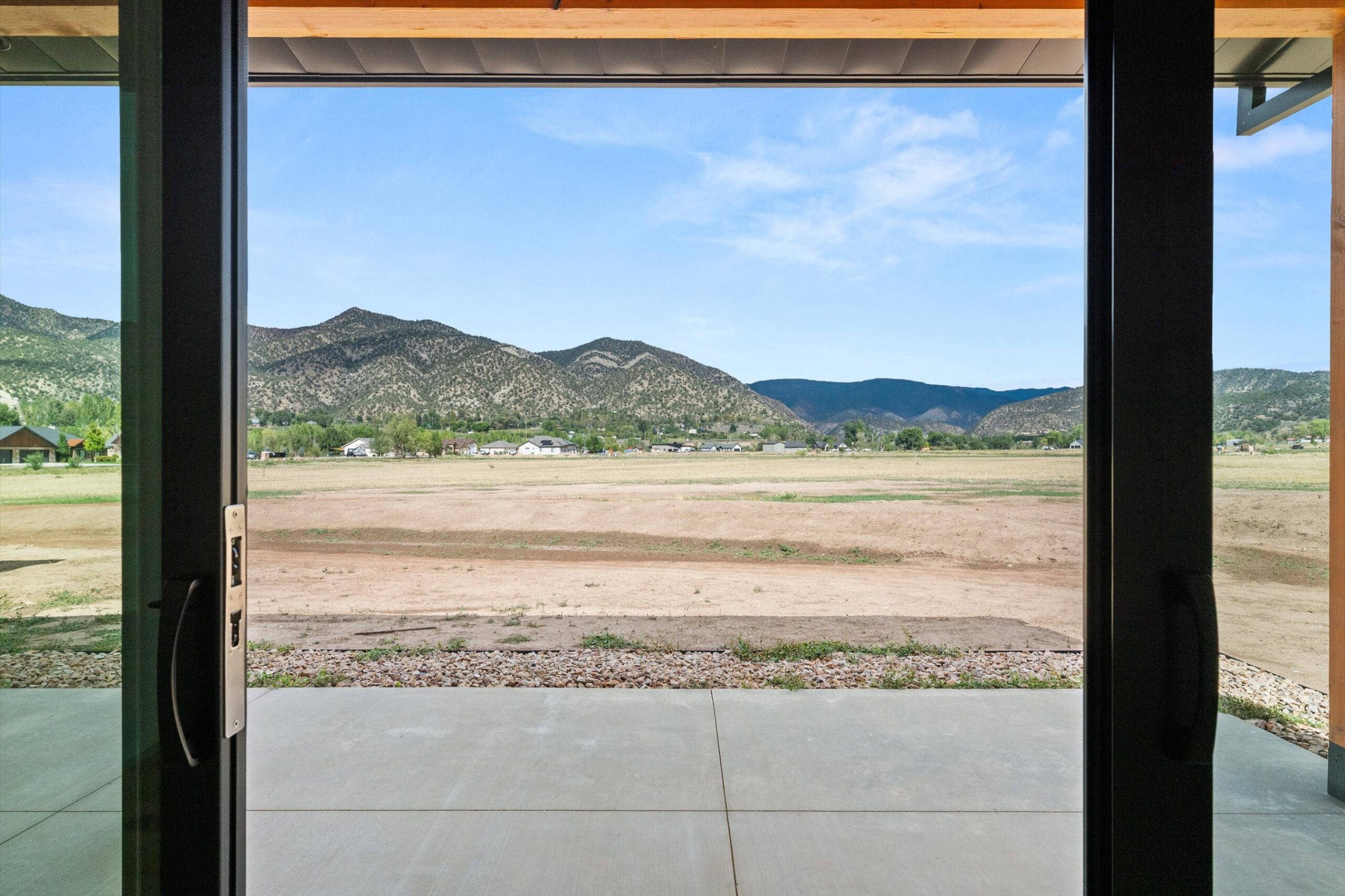 View through suite doors to patio and mountains