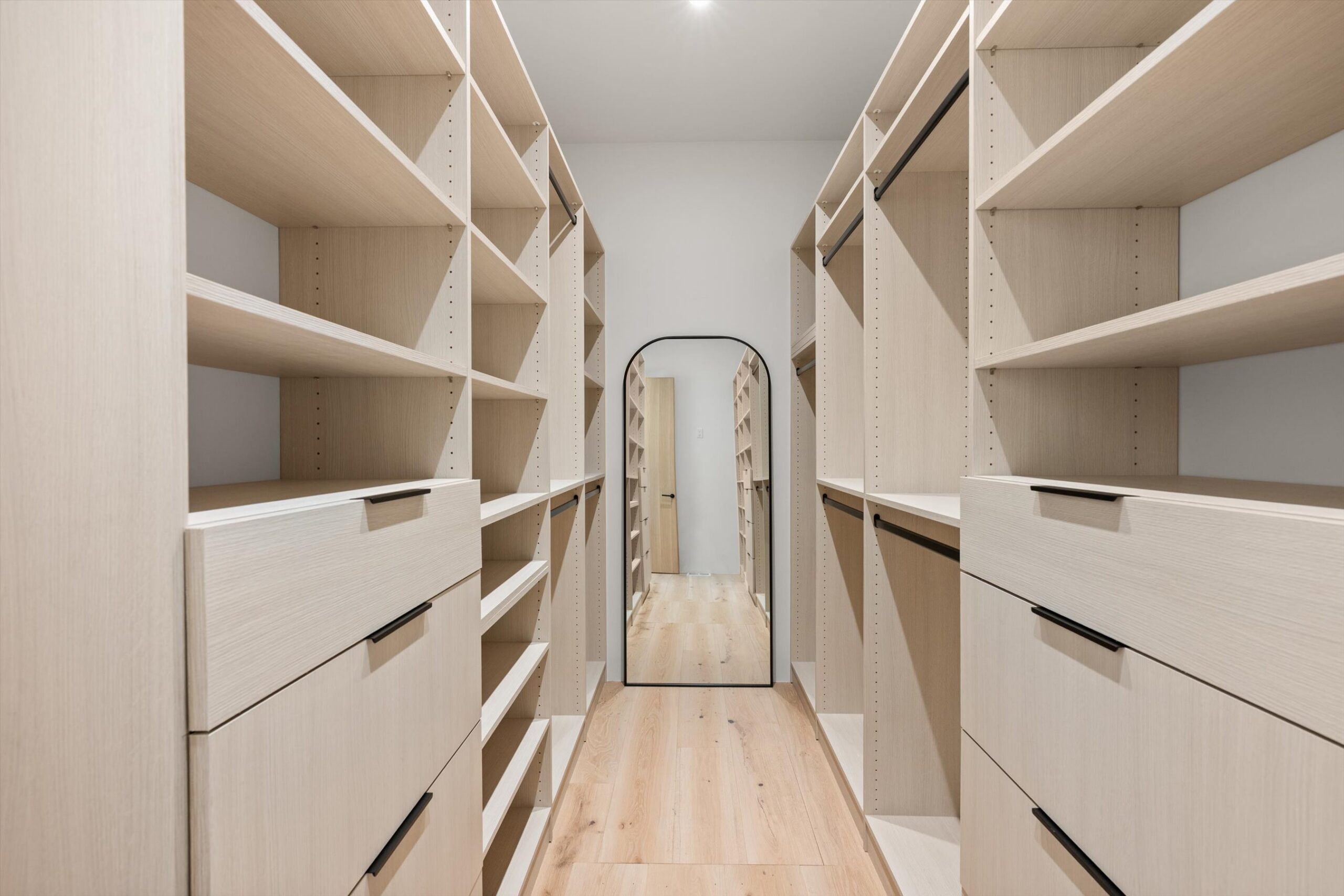 Primary walk-in closet with built-in shelving