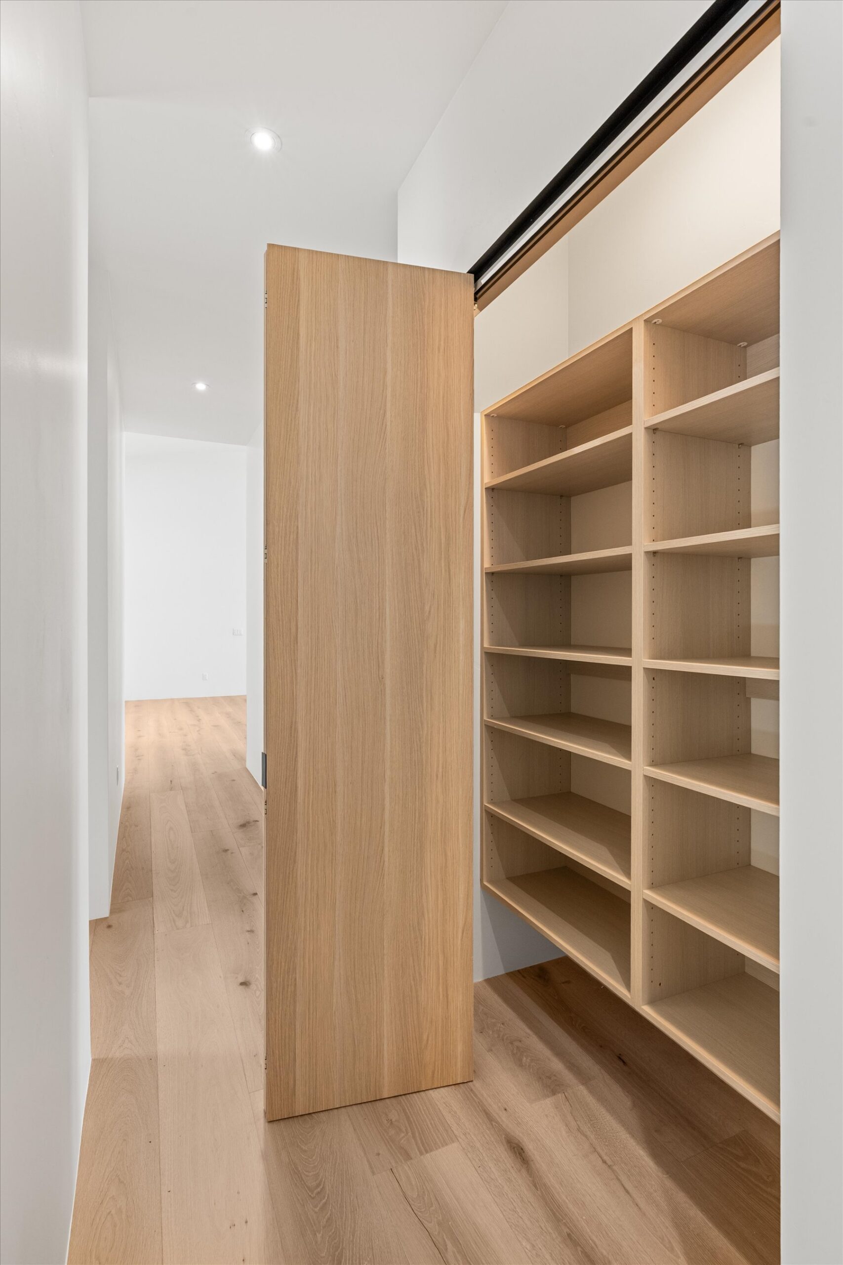 Hallway linen closet with built-in shelving