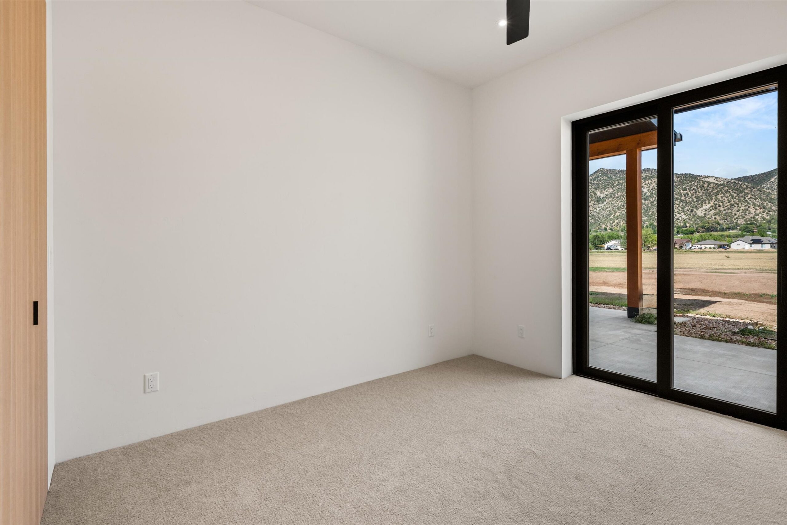 Secondary bedroom with sliding door to patio