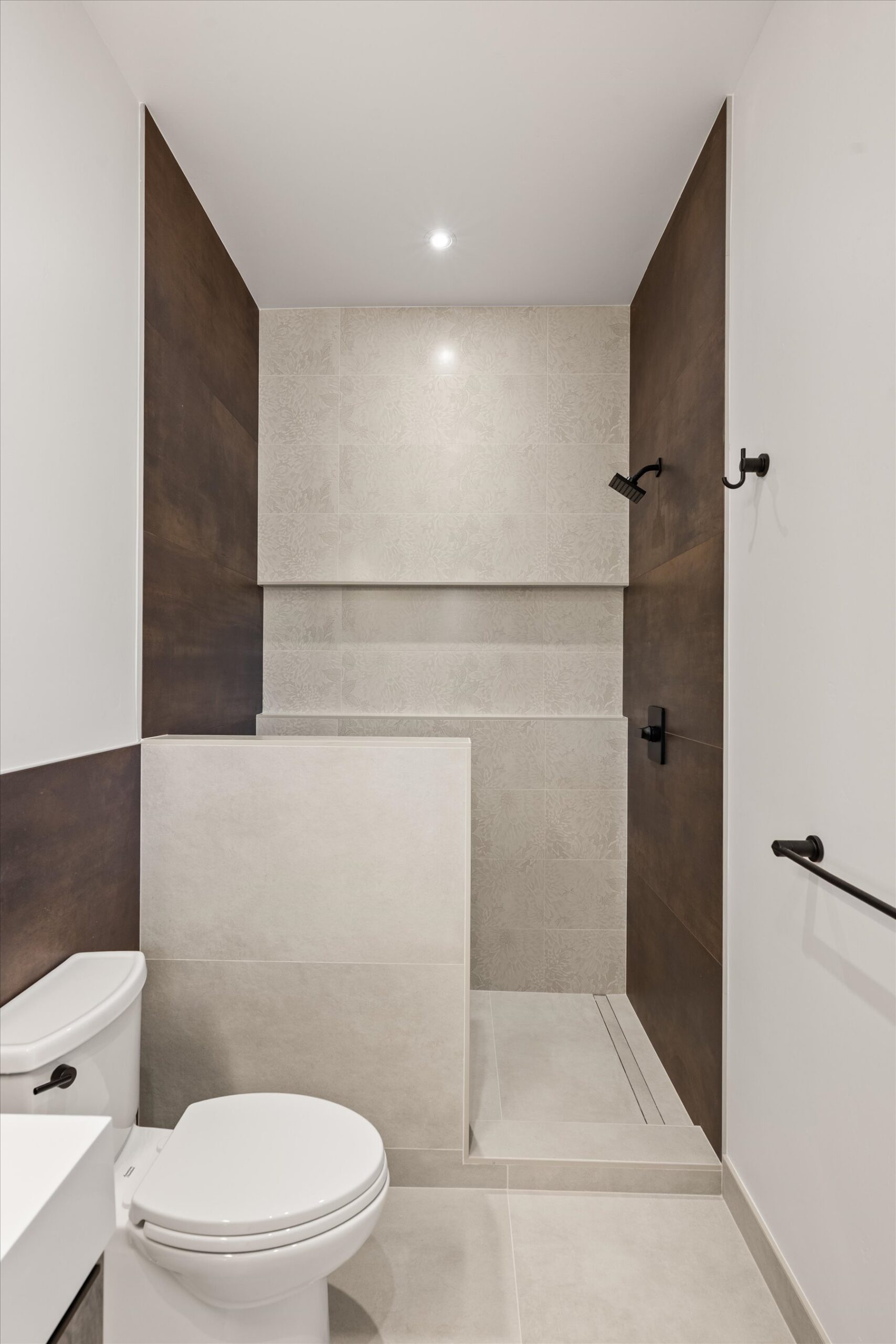 Walk-in shower with patterned tile surround