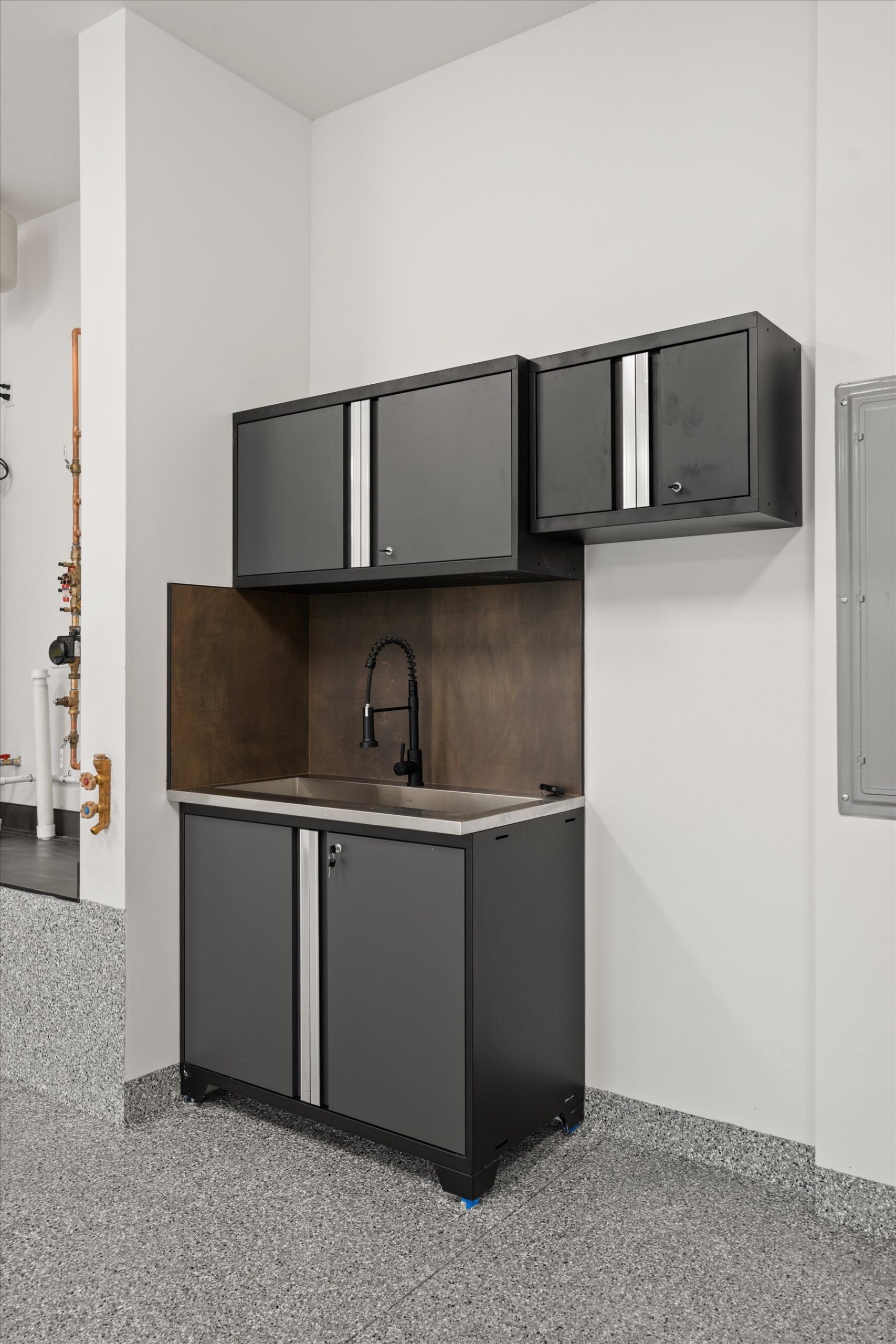 Garage utility sink with black cabinetry
